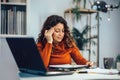 Woman holding papers in her hands, calculating family budget Royalty Free Stock Photo