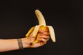 Woman holding peeled banana in her hand. Royalty Free Stock Photo