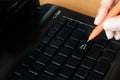 Woman holding pen with laptop pressing enter button Royalty Free Stock Photo