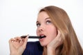 Woman holding pen to mouth Royalty Free Stock Photo