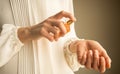 Woman spraying perfume on her hand Royalty Free Stock Photo