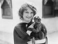 Woman holding a pet monkey in her arms