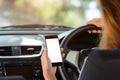 Woman holding phone in car white screen