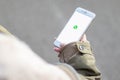 16. November 2019, SchwÃÂ¤bisch GmÃÂ¼nd, Germany: Woman holding a phone in the hands. WhatsApp logo on the cellphone screen