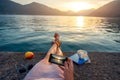 Woman holding phone lying on the pier Royalty Free Stock Photo