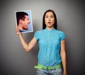 Woman holding photo of aggressive man