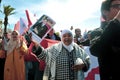 A woman holding a picture of the King of Morocco Royalty Free Stock Photo