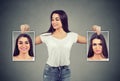 Woman holding pictures with good and bad emotions having mood swings and smiling at positive herself Royalty Free Stock Photo