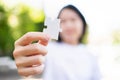 Woman holding a piece of jigsaw puzzle and standing in the garden with greenery background. Problem solving and strategy planing, Royalty Free Stock Photo