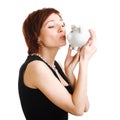 Woman holding piggy bank against white background