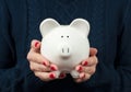 Savings concept. Woman holding piggy bank