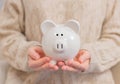 Woman is holding piggy bank in her hands Royalty Free Stock Photo