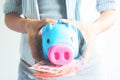 Woman holding piggy bank and Thai currency, Close up saving mone Royalty Free Stock Photo