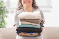 Woman holding a pile of folded laundry Royalty Free Stock Photo