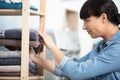 woman holding pile ironed clean towels