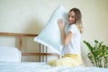 Woman holding a pillow while sitting on her bed Royalty Free Stock Photo