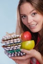 Woman holding pills and fruits. Health care Royalty Free Stock Photo