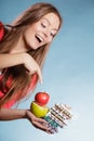 Woman holding pills and fruits. Health care Royalty Free Stock Photo