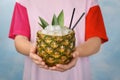 Woman holding pineapple with juice and ice cubes, Royalty Free Stock Photo