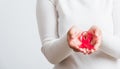 Woman holding pink breast cancer awareness ribbon on hands Royalty Free Stock Photo