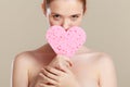 Woman holding pink heart sponge in hands. Royalty Free Stock Photo