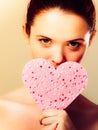 Woman holding pink heart sponge in hands. Royalty Free Stock Photo
