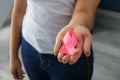 Woman holding pink ribbon, closeup. Breast cancer awareness concept Royalty Free Stock Photo