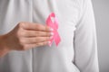 Woman holding pink ribbon, closeup. Breast cancer awareness concept Royalty Free Stock Photo