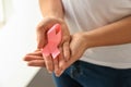 Woman holding pink ribbon, closeup. Breast cancer awareness concept Royalty Free Stock Photo