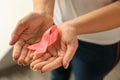 Woman holding pink ribbon, closeup. Breast cancer awareness concept Royalty Free Stock Photo