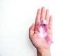 Woman holding pink ribbon on white background, top view. Breast cancer awareness concept, Woman hand holding pink breast cancer aw Royalty Free Stock Photo