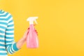 Woman hold pink spray bottle yellow home cleaning Royalty Free Stock Photo