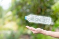 Woman holding plastic bottle glow by polygon design