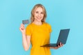 Woman holding plastic card and laptop computer, making online payment Royalty Free Stock Photo