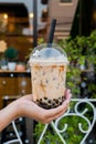 woman is holding a plastic cup of bubble milk tea Royalty Free Stock Photo