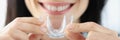 Woman holding plastic mouth guard for bruxism treatment closeup Royalty Free Stock Photo