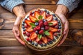 Woman holding plate with delicious berry pie on wooden background, top view. Ai generated Royalty Free Stock Photo