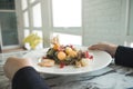 A woman holding a plate of mixed fruits salad Royalty Free Stock Photo