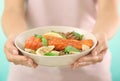 Woman holding plate with tasty salmon and fresh salad, closeup Royalty Free Stock Photo