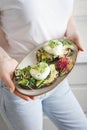 Woman  holding a plate with toast made with microgreens Royalty Free Stock Photo