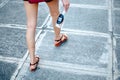 A woman is holding a platic bottle with water outdoor