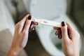 Woman holding a positive pregnancy test Royalty Free Stock Photo