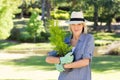 Woman holding pot plant in garden Royalty Free Stock Photo