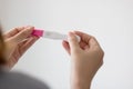 Woman Holding Pregnancy Test. hand holding pregnancy test and the result is pregnant. Royalty Free Stock Photo