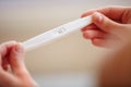 Woman Holding Pregnancy Test. Not pregnant. Royalty Free Stock Photo