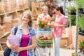 Woman holding purple pot in garden center Royalty Free Stock Photo