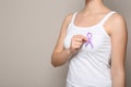 Woman holding purple ribbon on grey background, closeup. Domestic violence awareness Royalty Free Stock Photo