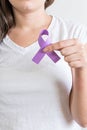 Woman holding a purple ribbon of the International Day for the Elimination of Violence Against Women Royalty Free Stock Photo