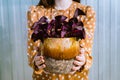 Woman holding purple shamrock or Oxalis triangularis plant