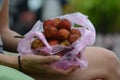 A Woman holding Rambutan Nephelium lappaceum exotic fruit Royalty Free Stock Photo